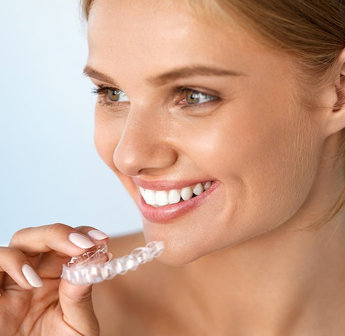 woman ready to put in her Invisalign aligners in